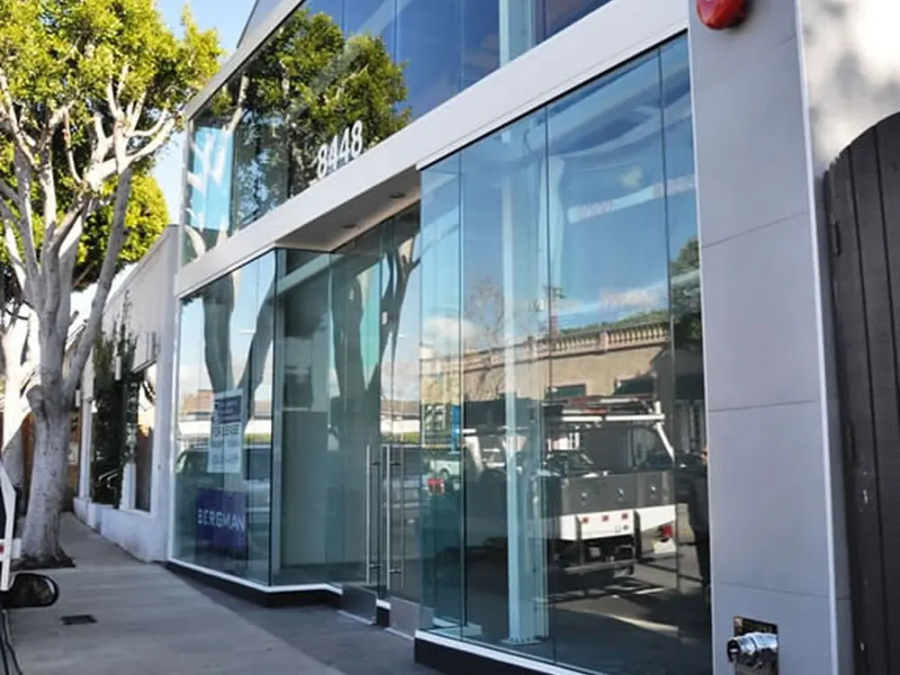 A glass commercial entrance carrying safety film across every pane.