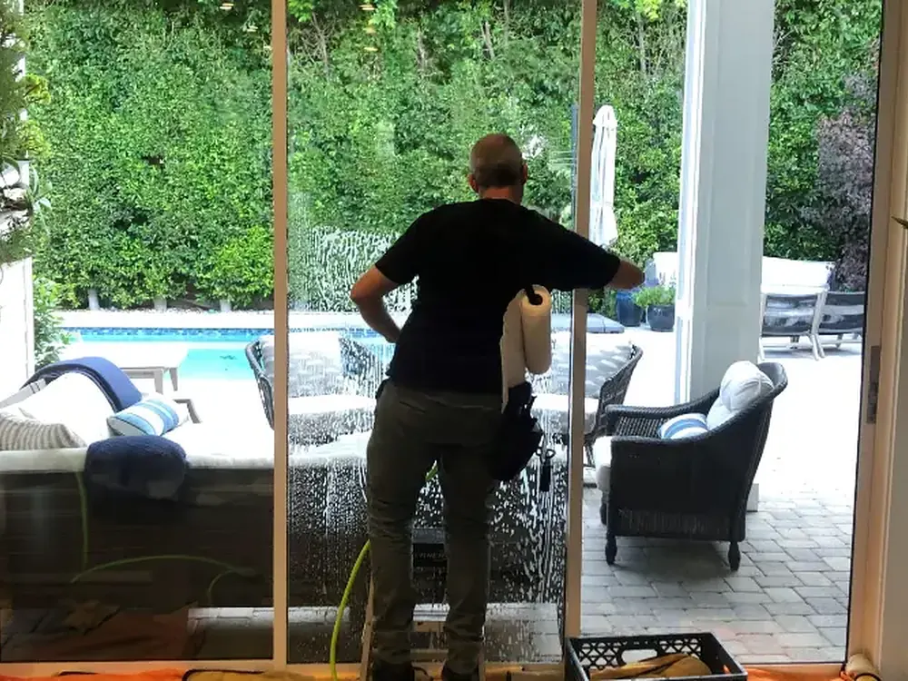 A technician mid-install on residential sliding glass doors.