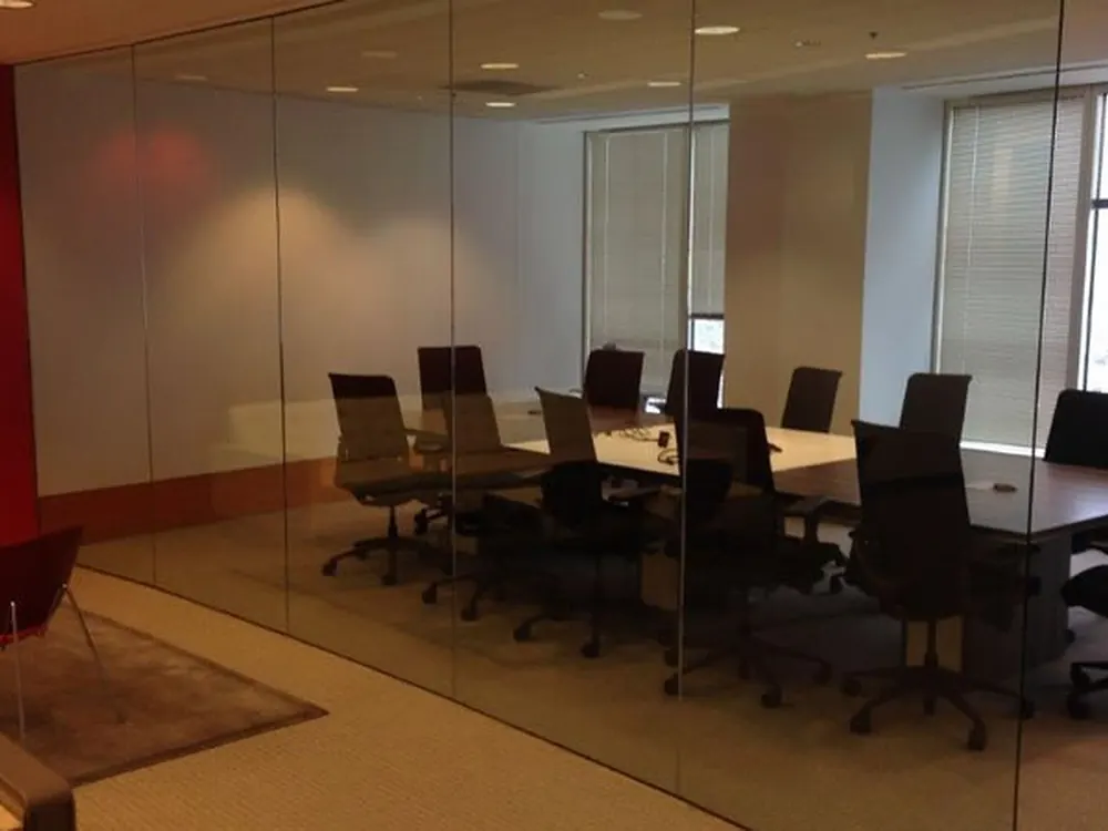 Clear glass partitions around a boardroom, before frosted film went on.
