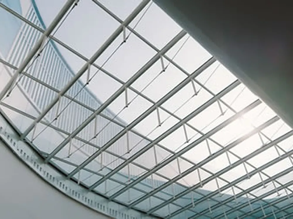 Looking up at a run of skylight panels carrying heat-rejection film.